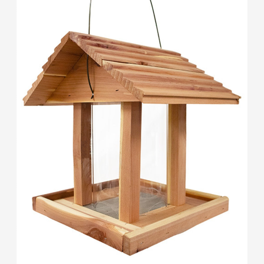 Eco-friendly Amish Made Cedar Hopper Feeder with a seed cylinder, ideal for backyard birdwatching and feeding